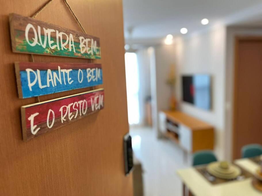a door in a room with signs on the wall at Mar & Descanso Itaparica in Vila Velha