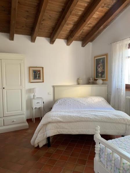 a bedroom with a white bed and a window at [Suite Elicriso] in Varzi