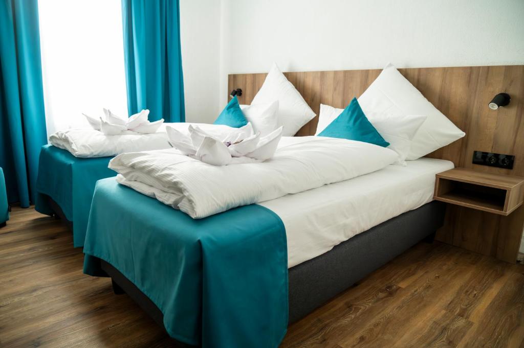 Postel nebo postele na pokoji v ubytování Hotel Hansa Stuttgart City
