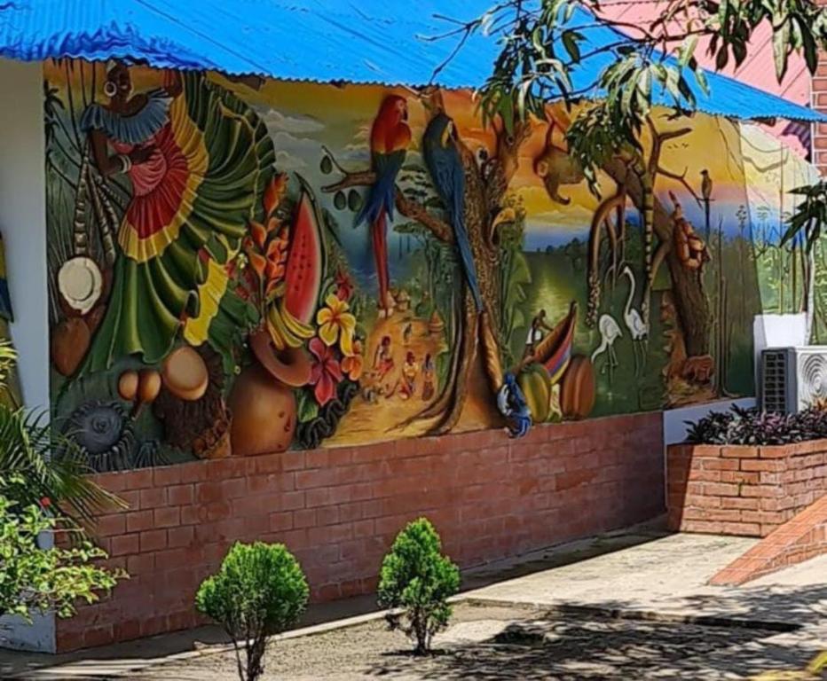 a mural of fruits and vegetables on a wall at HOTEL CASA BLANCA in Necoclí