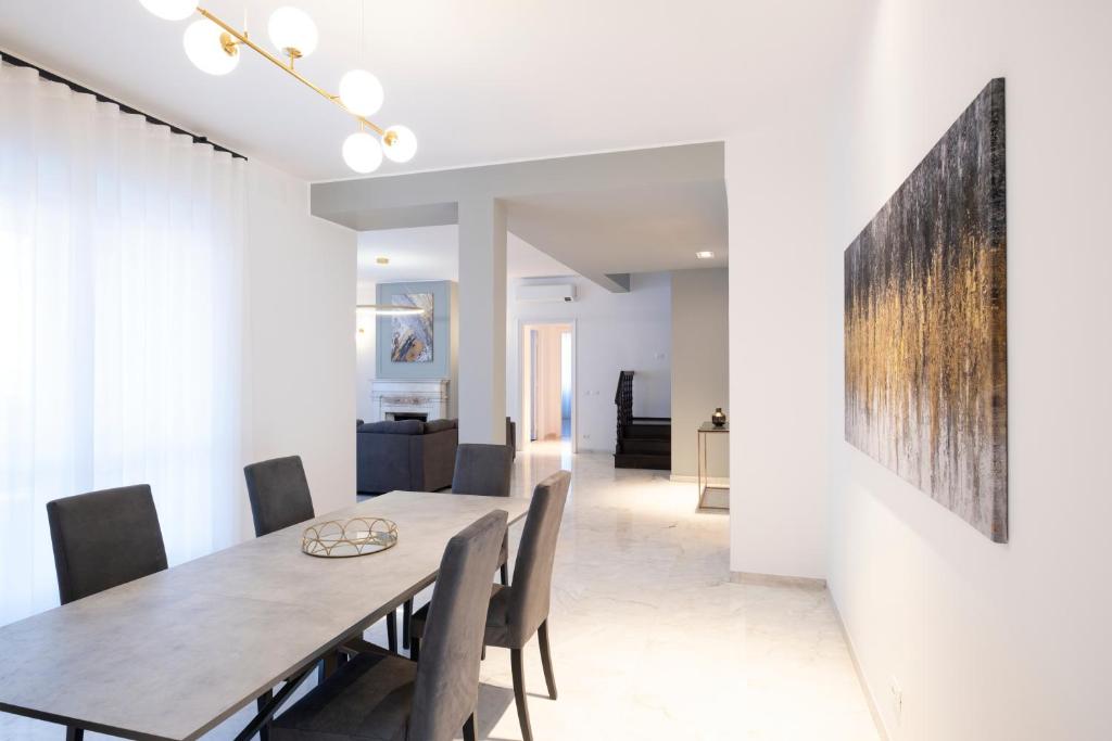 a dining room with a table and chairs at Savoia Luxury Penthouse in Rome