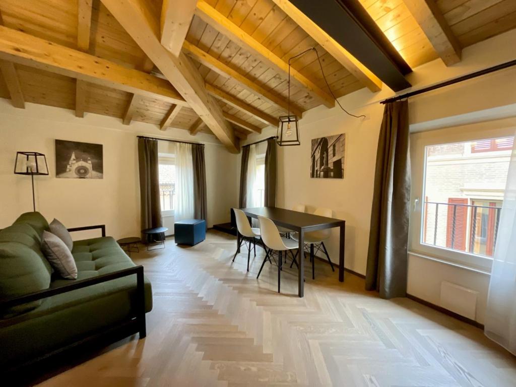 a living room with a couch and a table at Appartamenti Saragozza a due passi da Piazza Grande - WIFI e parcheggio gratuito in Modena