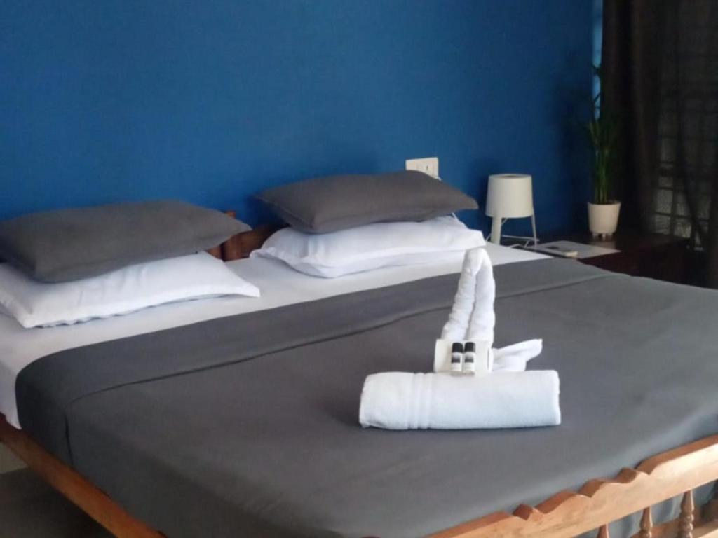a bed with a bunny made out of a towel at Mad about Coco Yoga & Beach Retreat in Varkala