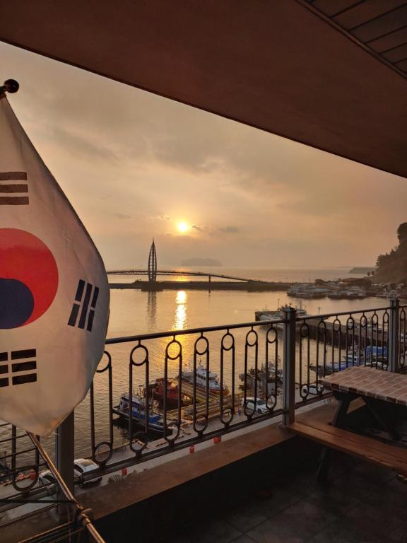 a view from the balcony of a cruise ship at sunset at Seom Guesthouse in Seogwipo