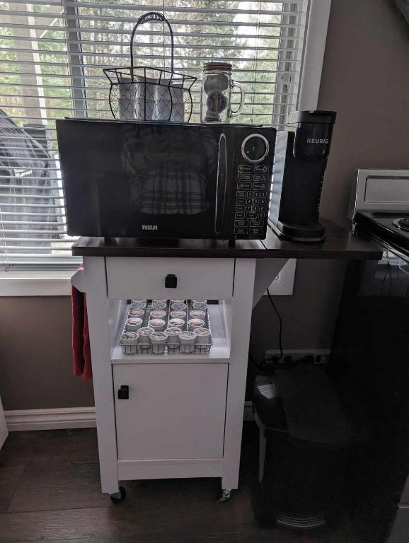 a microwave sitting on top of a table with a stove at Suite in the Bush-Private Apartment in Bancroft