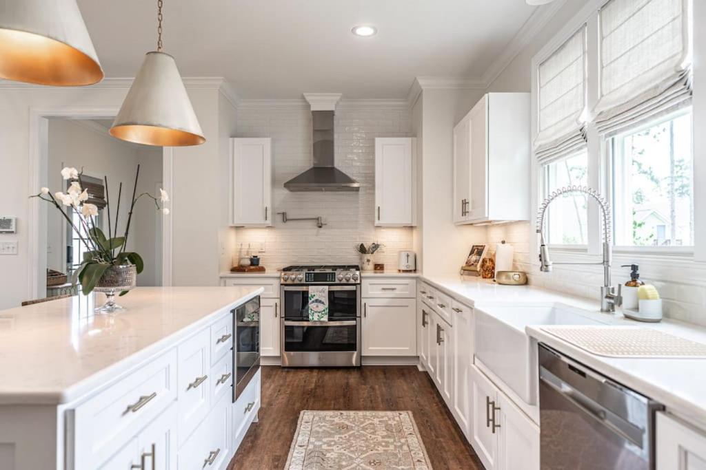 a white kitchen with white cabinets and a sink at Sleeps 6-Southern Pines in Southern Pines
