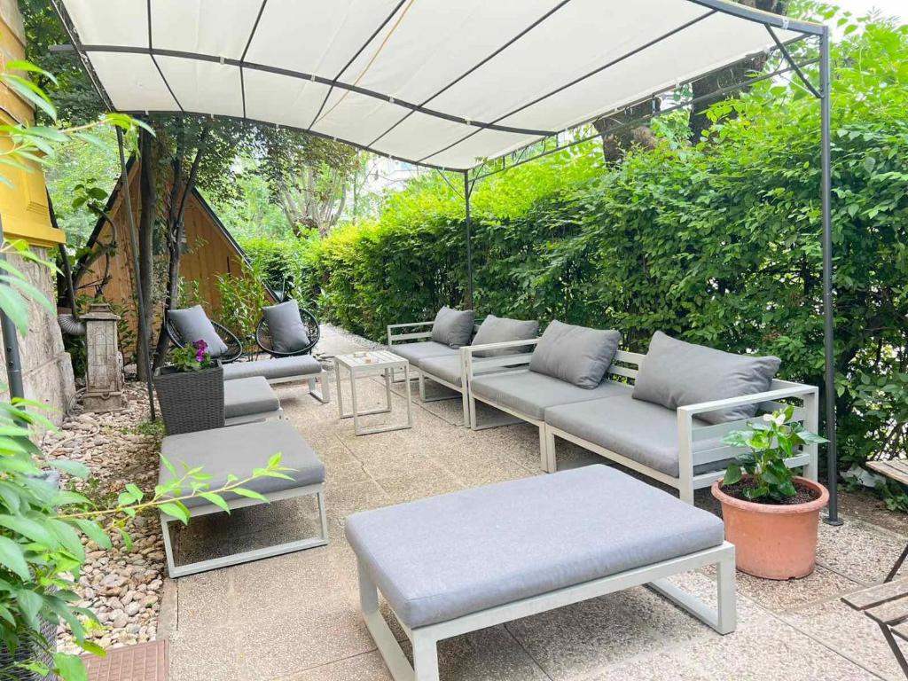 a group of couches sitting under an umbrella at VV way - Lisica zvitorepka in Ljubljana