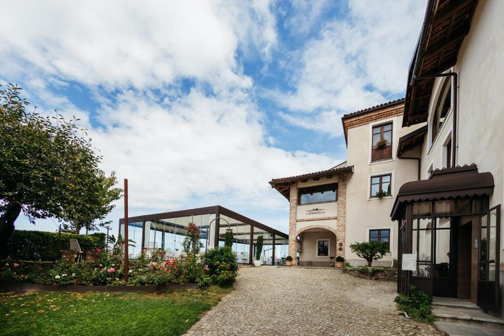 a house with a pathway leading to a building at Agriturismo La Torricella in Monforte dʼAlba