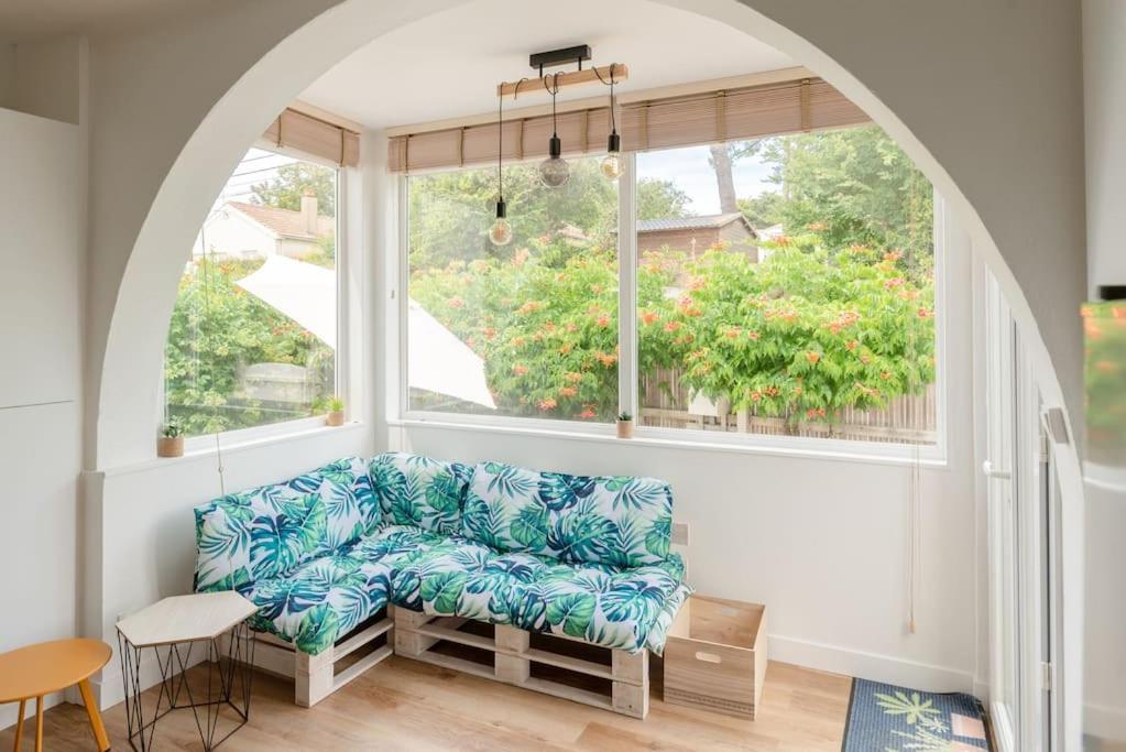 a living room with a couch in front of a window at Charmante maison à 100M de la plage in Pornic