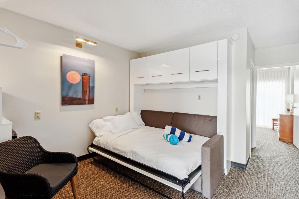a bedroom with a bed and a chair in it at Cape Suites Room 8 - Free Parking! Hotel Room in Rehoboth Beach