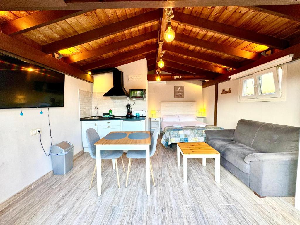 a living room with a couch and a table at 3 Casita-Estudio con Jardín en la playa in Puerto Marino