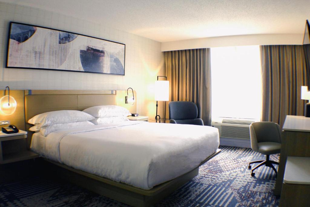 a hotel room with a large bed and a large window at Southpark Hotel in Colonial Heights