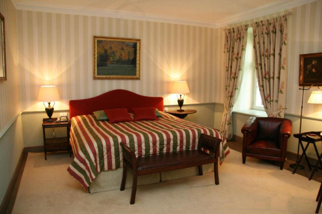 Postel nebo postele na pokoji v ubytování Hotel Château Bela