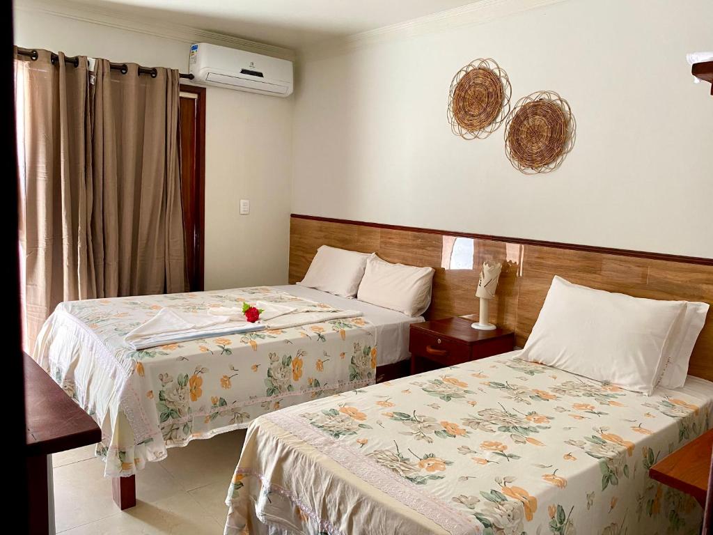 Cama ou camas em um quarto em Pousada Paraíso dos Milagres