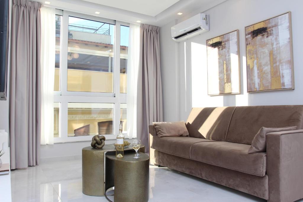 a living room with a couch and a table at central metropolis luxury living in Athens