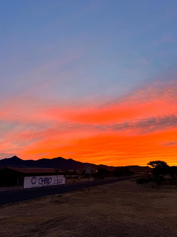 a sunset in the desert with a red sky at HOTEL SAN ROMAN in Sombrerete