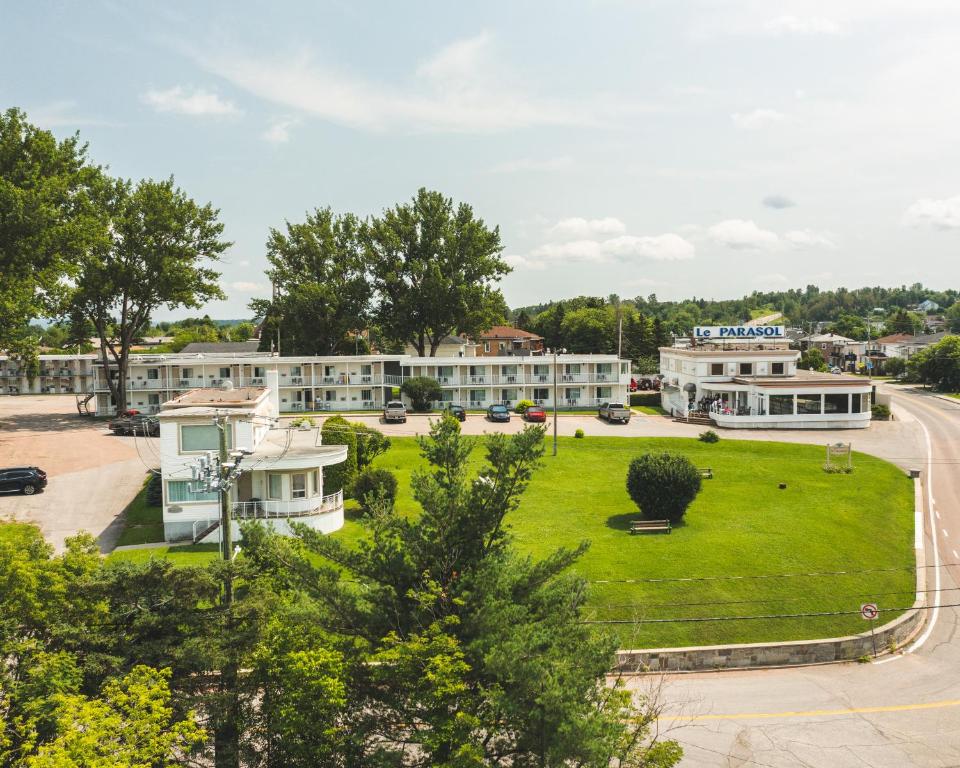 arial view of a town with a park and buildings at Auberge le Parasol in Saguenay