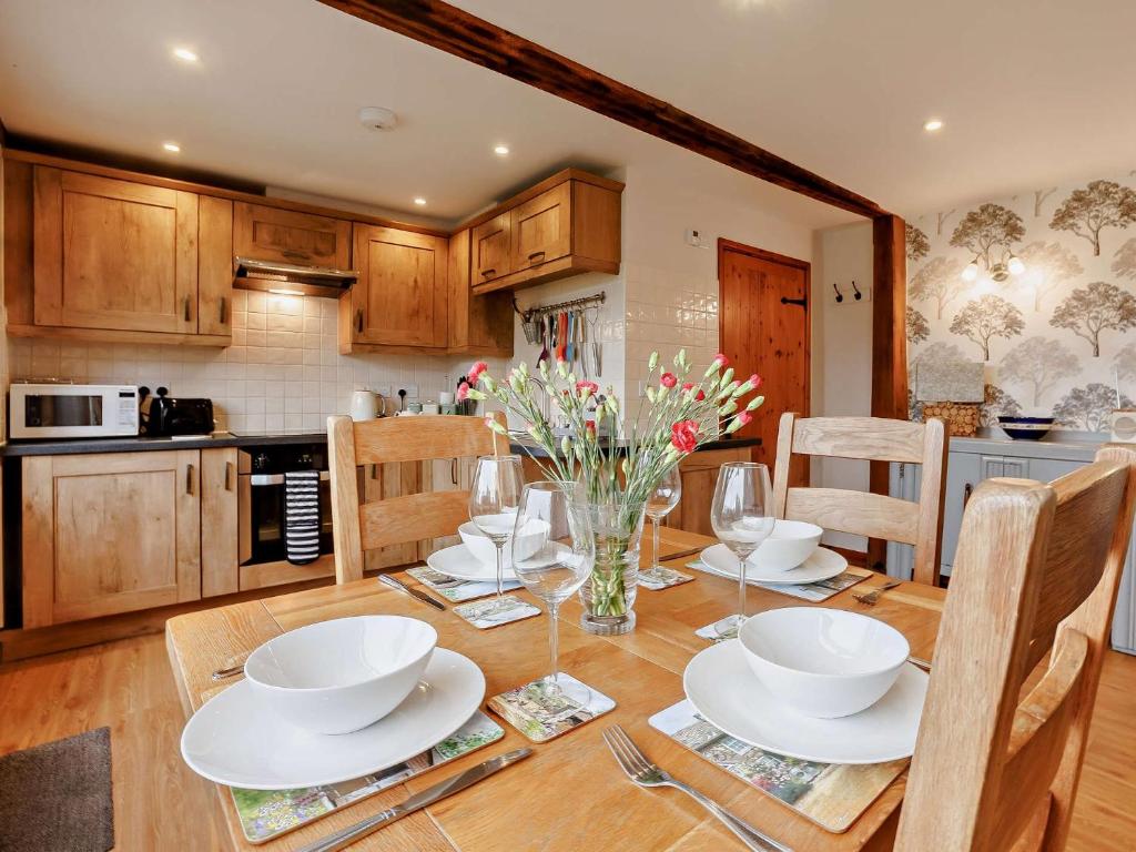 a kitchen with a wooden table with white dishes on it at 2 Bed in Launceston BRDEX in Launceston