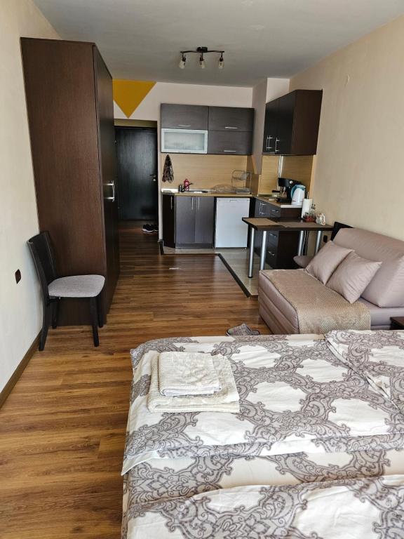 a living room with a bed and a kitchen at City Sandanski in Sandanski