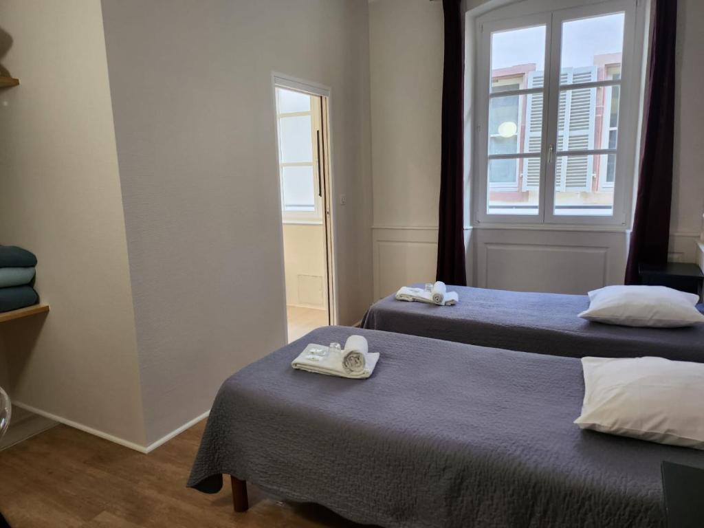 Postel nebo postele na pokoji v ubytování Hôtel Patricia - Strasbourg Hyper Centre