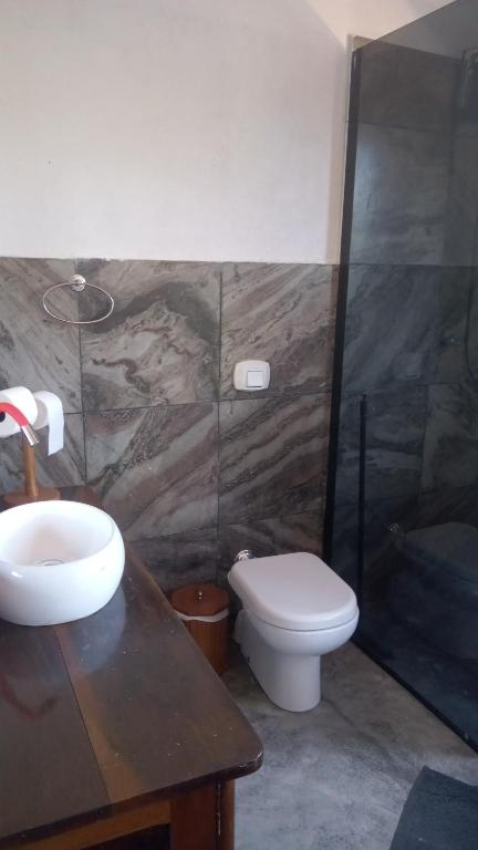 a bathroom with a sink and a toilet at Casa Magia in Bombinhas