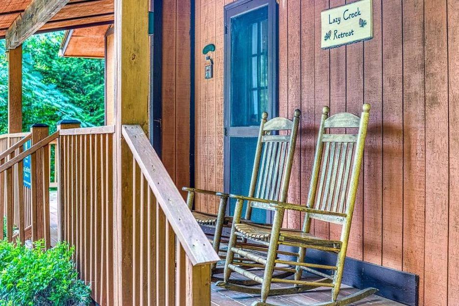 two rocking chairs sitting on the porch of a house at Lazy Creek Retreat in Gatlinburg
