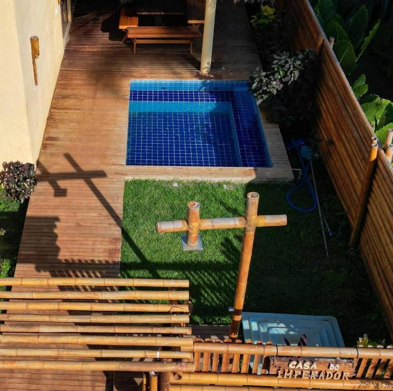an overhead view of a swimming pool on a wooden deck at Casa do Imperador in Fernando de Noronha