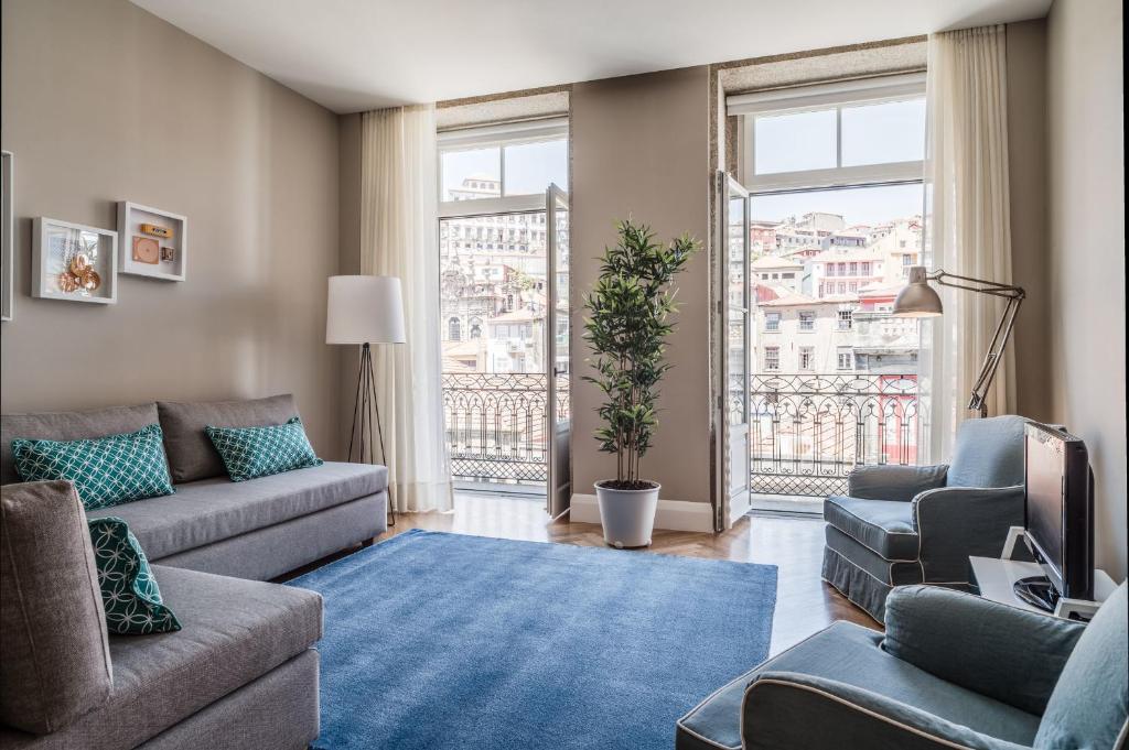 a living room with couches and a large window at Mouzinho 160 in Porto