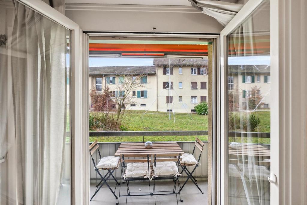 a patio with a table and chairs on a balcony at Cozy 2 Bedroom Apartment in Zurich in Zürich