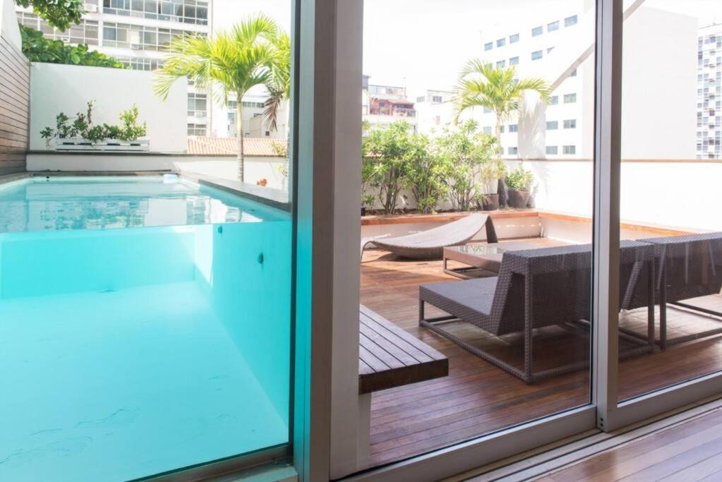 a view of a swimming pool from a building at 4 Bedroom Penhouse with Pool in Leblon 012 in Rio de Janeiro