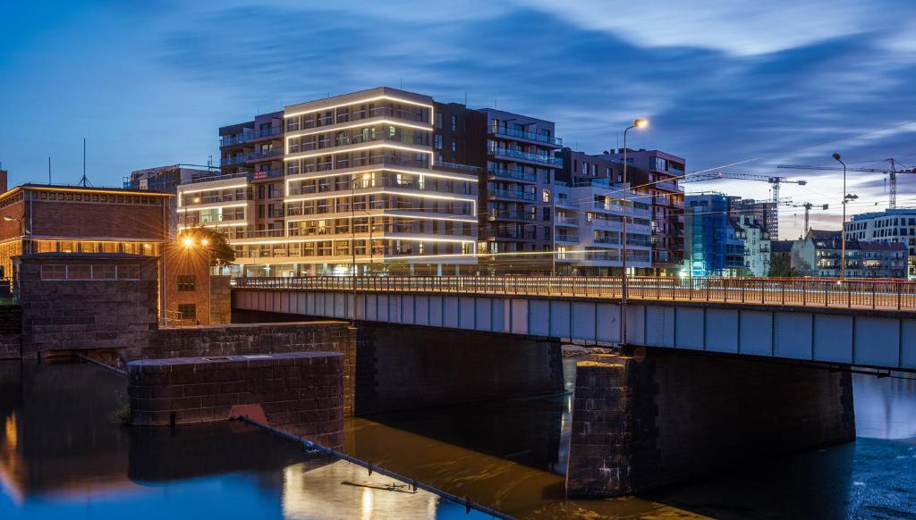 a bridge over a river in a city with buildings at Dream4You Apartments in Wrocław