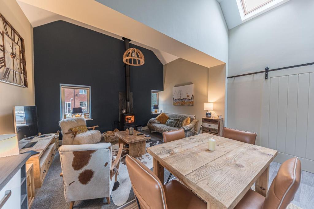 a living room with a table and chairs at Hodbarrow House in Millom