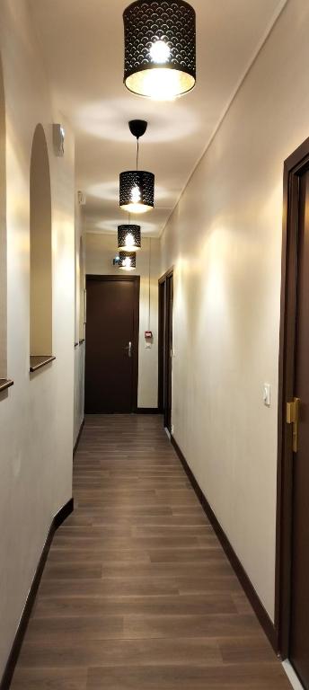 a hallway of an office with two lights on the ceiling at HÔTEL ROYAL MONTREUIL in Montreuil