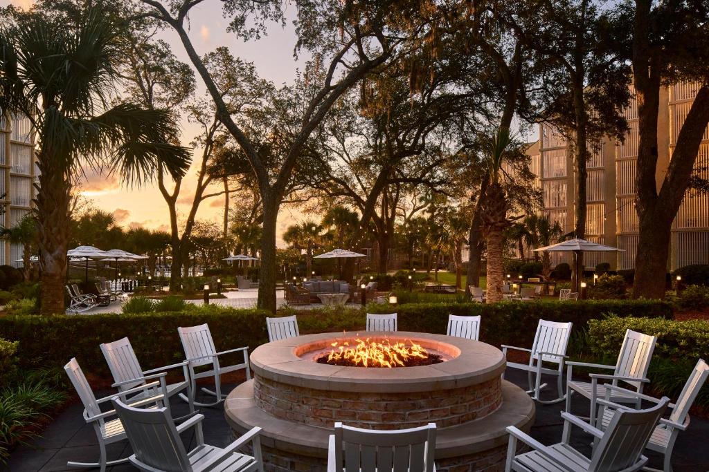 a group of white chairs sitting around a fire pit at Omni Hilton Head Oceanfront Resort in Hilton Head Island
