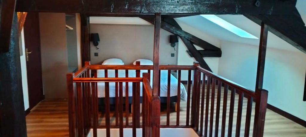 a staircase leading up to a room with a ceiling at HÔTEL ROYAL MONTREUIL in Montreuil