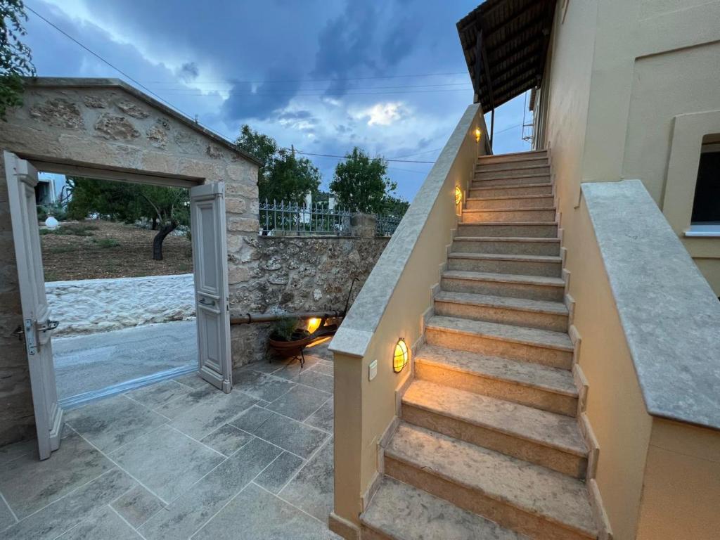 a staircase leading up to a house with a patio at Vivi's Apartments in Spetses