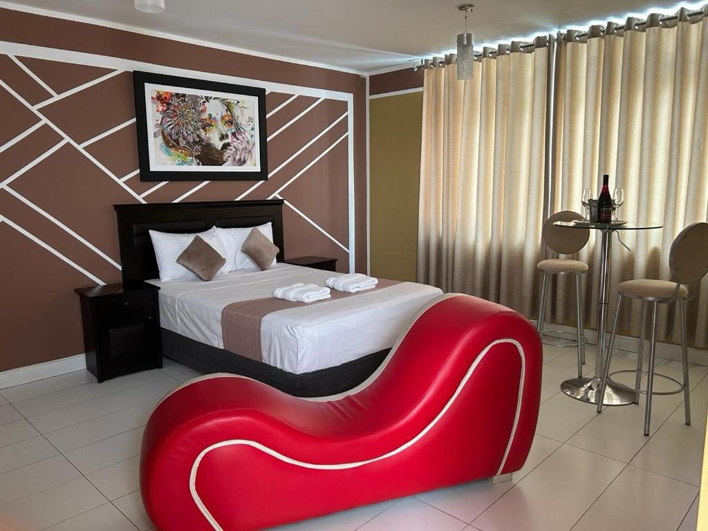 a bedroom with a red bench in front of a bed at GOLDEN DREAM´S in Lima