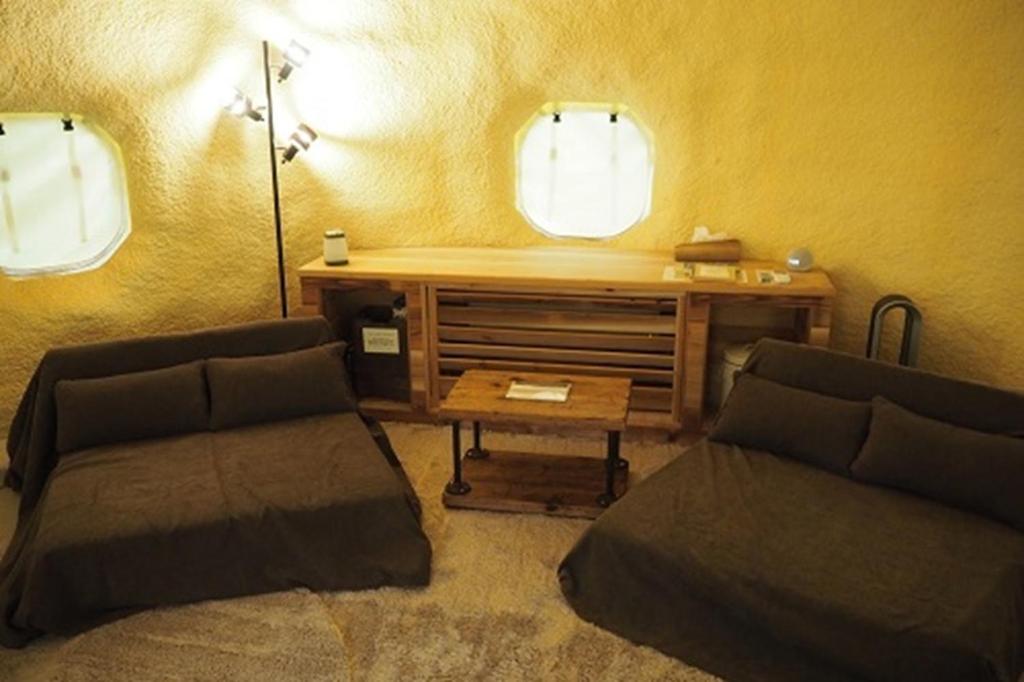 a living room with two beds and a desk at Ashigarakami-gun - Camp - Vacation STAY 84740v in Hokizawa