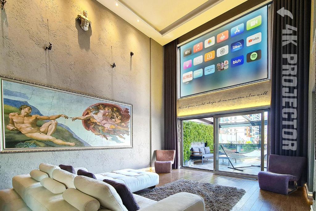 a living room with a couch and a large tv at The Best Experience in Ankara in Ankara