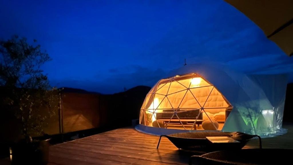 a large dome tent on a deck at night at OLUOLU GLAMPING - Vacation STAY 84744v in Hirota