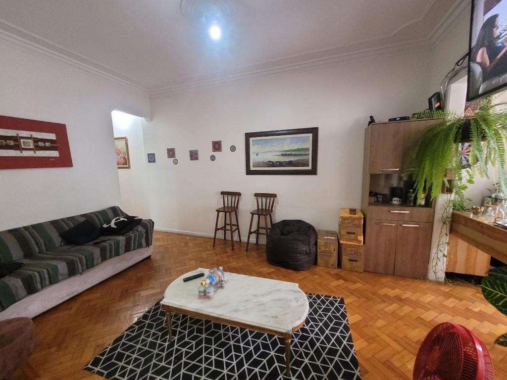 a living room with a couch and a table at SuhcasaCopacabana 48 Spacious in Rio de Janeiro