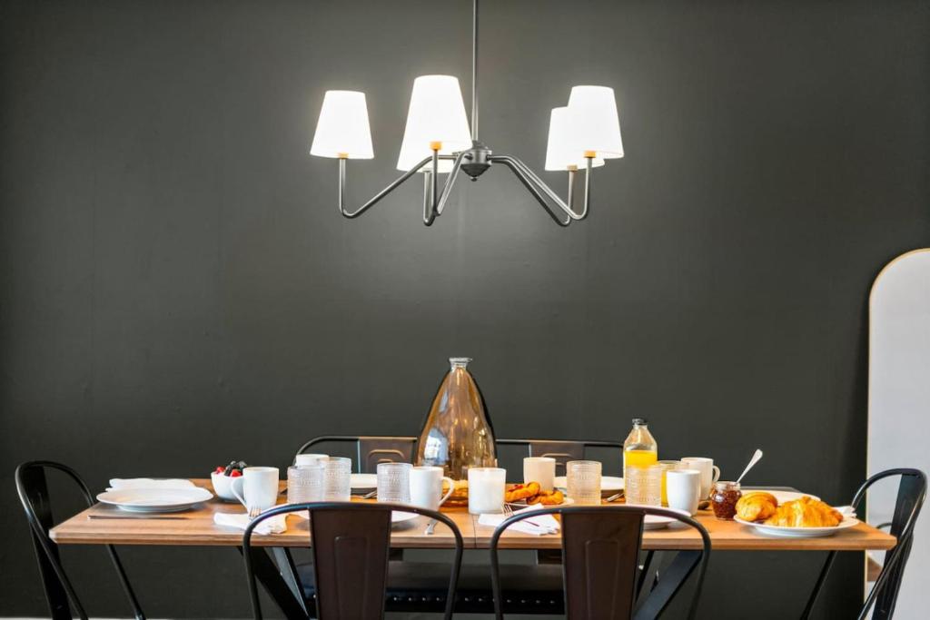 a dining room table with food and two lights at Peaceful DC Getaway Near Metro in Arlington