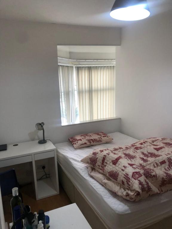 a small bedroom with a bed and a window at Fast book Homes. Close to Uni in Hull