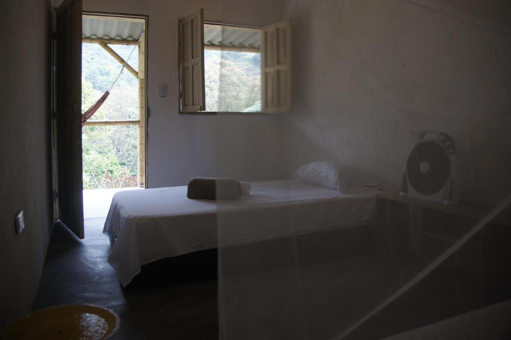 Postel nebo postele na pokoji v ubytování Hostal Vista Verde Minca