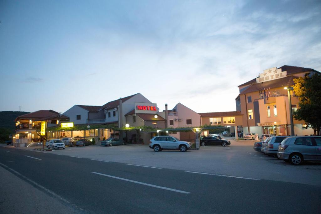 a city street with cars parked in a parking lot at Motel Konak Mosko in Trebinje