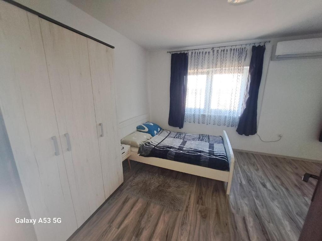 a small bedroom with a bed and a window at Apartman T&N 