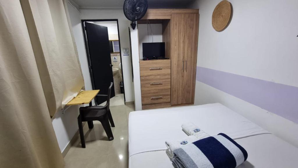Postel nebo postele na pokoji v ubytování Aparta Hotel la 80 Estadio