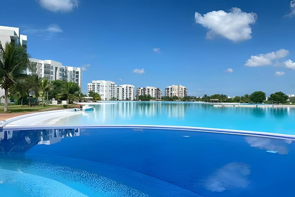 a large blue swimming pool with buildings in the background at Dream Lagoons Veracruz in Veracruz