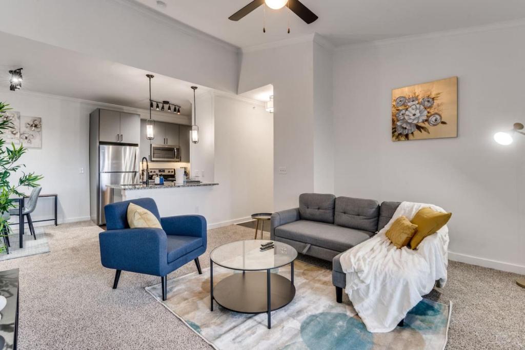a living room with a couch and chairs and a table at Luxury 1Bedroom Apt with Pool in Austin