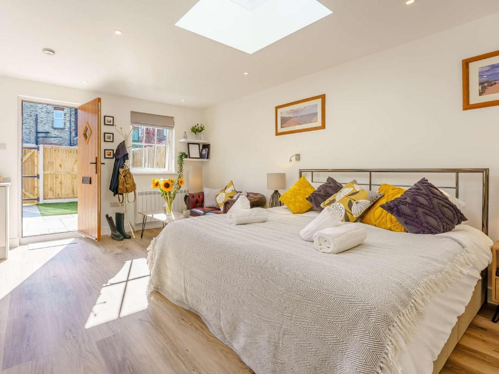 a bedroom with a large bed with yellow pillows at 1 Bed in Broadstairs 89391 in Broadstairs
